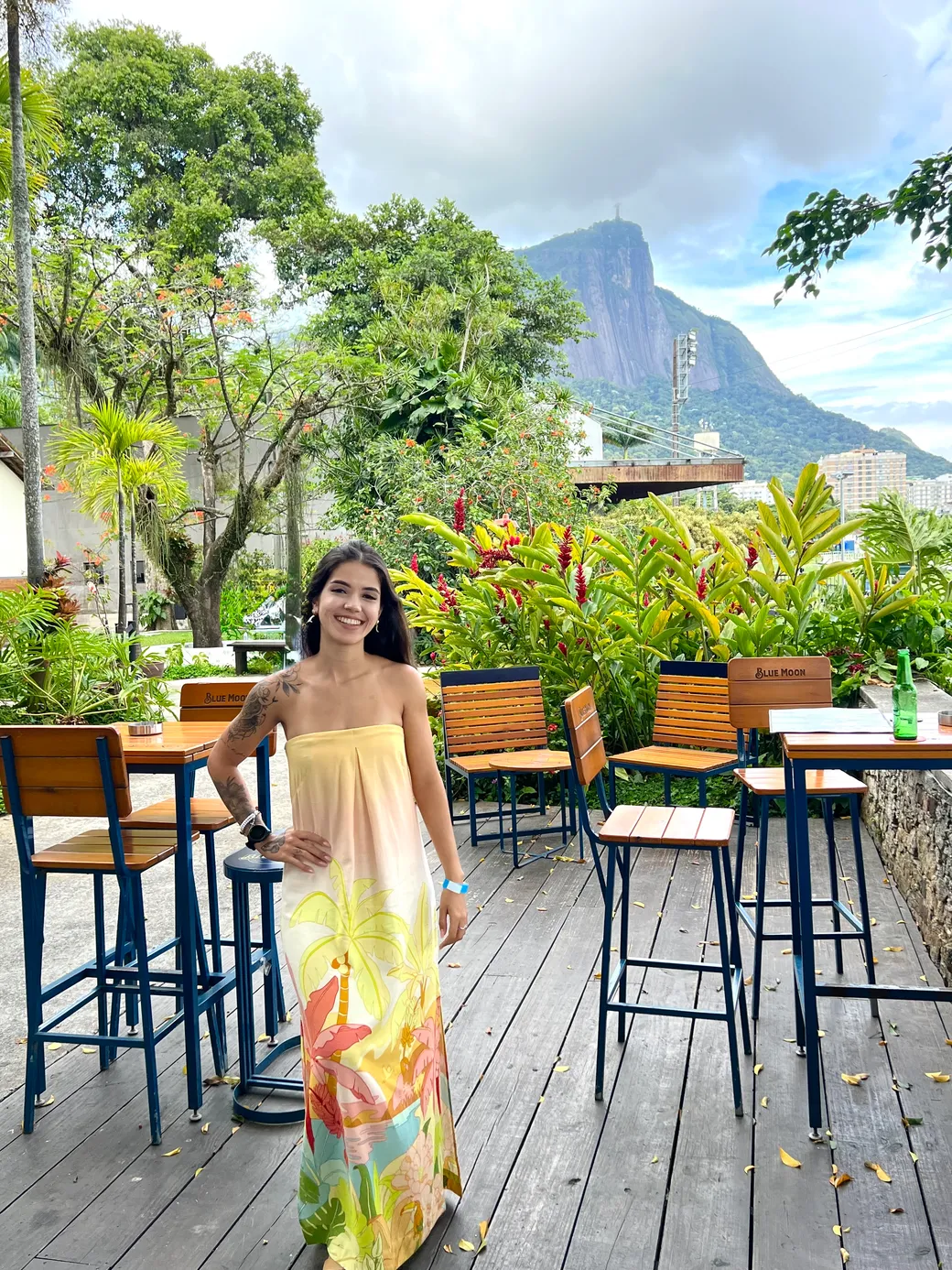 Anne Caroline on the garden terrace at the Jockey Club in Gávea, Rio de Janeiro, with Cristo Redentor on Corcovado behind her